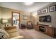 Cozy living room with plush seating, tv, storage, and an open doorway to the bedroom at 3427 Forest Bridge Cir, Brandon, FL 33511