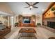 The carpeted living room features a brick fireplace, ceiling fan, and custom built-in shelves at 3427 Forest Bridge Cir, Brandon, FL 33511