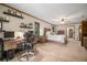 Well-lit main bedroom offers carpeting, a ceiling fan, work space, and a comfortable king bed at 3427 Forest Bridge Cir, Brandon, FL 33511