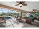 An enclosed patio featuring a pool, rocking chair, ceiling fan and billiard table at 3427 Forest Bridge Cir, Brandon, FL 33511