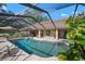 A refreshing in-ground pool surrounded by a screened enclosure, patio, and lush greenery at 3427 Forest Bridge Cir, Brandon, FL 33511