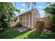 Backyard shed with neutral paint, double doors, and a brick base, perfect for storage or a hobby space at 3427 Forest Bridge Cir, Brandon, FL 33511