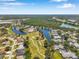 High aerial view of a community near a pond, a golf course, and a highway, in a very green setting at 3610 Montero Ct, Sun City Center, FL 33573