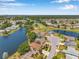 Beautiful aerial view of neighborhood near a pond and golf course in a serene setting at 3610 Montero Ct, Sun City Center, FL 33573