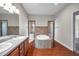 Bathroom with double sinks, large tub and dual glass shower stalls at 3610 Montero Ct, Sun City Center, FL 33573