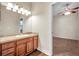 Bathroom boasts a wood vanity with a sink and a view into a bedroom with carpet and ceiling fan at 3610 Montero Ct, Sun City Center, FL 33573