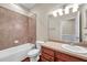 This bathroom features a shower over bath, vanity with cabinets, and neutral color scheme, creating a relaxing space at 3610 Montero Ct, Sun City Center, FL 33573