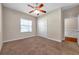 Neutral bedroom showcases a ceiling fan, closet, and window for natural light, with neutral carpeting at 3610 Montero Ct, Sun City Center, FL 33573