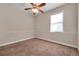 This bedroom features neutral walls, brown carpet, ceiling fan, and lots of natural light from the window at 3610 Montero Ct, Sun City Center, FL 33573
