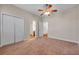 Bedroom shows a ceiling fan, doorways to other rooms, and a closet, and neutral carpeting at 3610 Montero Ct, Sun City Center, FL 33573