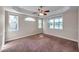 Bright bedroom featuring a ceiling fan, multiple windows, neutral paint and plush carpet at 3610 Montero Ct, Sun City Center, FL 33573