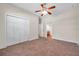 Neutral bedroom boasts a ceiling fan, closet, and doorways to other rooms, with neutral carpeting at 3610 Montero Ct, Sun City Center, FL 33573