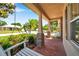 The cozy front porch features brick columns, a porch swing, and lush landscaping for a welcoming exterior at 3610 Montero Ct, Sun City Center, FL 33573