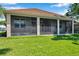 Large screened porch with ceiling fan overlooking the lush backyard, perfect for relaxing or entertaining at 3610 Montero Ct, Sun City Center, FL 33573