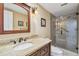 Bright bathroom with granite counter top vanity and a walk in glass shower at 36750 Us 19 N # 06111, Palm Harbor, FL 34684