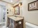 Cozy bathroom with dark wood vanity with granite countertop and a decorative framed mirror at 36750 Us 19 N # 06111, Palm Harbor, FL 34684