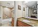 Bathroom with granite vanity, neutral tiling, and a bathtub with a shower head at 36750 Us 19 N # 06111, Palm Harbor, FL 34684