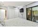 Well-lit bedroom features sliding glass doors to the outside at 36750 Us 19 N # 06111, Palm Harbor, FL 34684