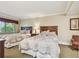 Inviting bedroom features two beds with decorative pillows, and a corner chair at 36750 Us 19 N # 06111, Palm Harbor, FL 34684