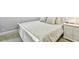Comfortable bedroom features white wooden bed frame and matching nightstand with a lamp at 36750 Us 19 N # 06111, Palm Harbor, FL 34684