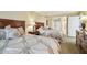 Warm bedroom with two beds, a nightstand, and a dresser for a comfortable stay at 36750 Us 19 N # 06111, Palm Harbor, FL 34684