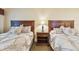 Cozy bedroom featuring two beds with stylish matching bedding and a shared nightstand at 36750 Us 19 N # 06111, Palm Harbor, FL 34684