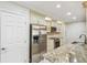 Modern kitchen featuring stainless steel appliances, granite countertops, and ample cabinet space at 36750 Us 19 N # 06111, Palm Harbor, FL 34684