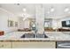 Open kitchen layout with granite counters, pendant lights, and seamless access to living and dining spaces at 36750 Us 19 N # 06111, Palm Harbor, FL 34684
