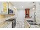 Modern kitchen featuring stainless steel appliances, granite countertops, and travertine floors at 36750 Us 19 N # 06111, Palm Harbor, FL 34684