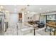 Open-concept living room with travertine floors, granite counters, and a seamless flow to dining area at 36750 Us 19 N # 06111, Palm Harbor, FL 34684