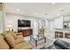 Comfortable living room featuring a large TV, seating, and access to the kitchen area at 36750 Us 19 N # 06111, Palm Harbor, FL 34684