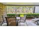 Outdoor patio with seating overlooking lush landscaping and a golf course at 36750 Us 19 N # 06111, Palm Harbor, FL 34684