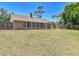 Expansive backyard featuring a large lawn and a screened-in porch area, perfect for outdoor living and entertaining at 3810 Hollister Pl, Brandon, FL 33511