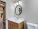 Charming bathroom with wood vanity, modern lighting, and a decorative mirror at 3810 Hollister Pl, Brandon, FL 33511