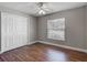 Bedroom with wood floors, ceiling fan, closet and window at 3810 Hollister Pl, Brandon, FL 33511