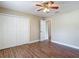 This well-lit bedroom features wood-look flooring, ceiling fan and double-door closet at 3810 Hollister Pl, Brandon, FL 33511