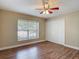 This bright bedroom features a window, double-door closet and wood-look flooring at 3810 Hollister Pl, Brandon, FL 33511