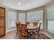 Dining room featuring wood floors, large windows and views of the backyard at 3810 Hollister Pl, Brandon, FL 33511