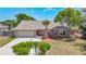 Inviting single-story home with manicured lawn, brick accents, fresh landscaping, and an attached two-car garage at 3810 Hollister Pl, Brandon, FL 33511