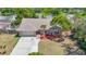 Charming single-story home featuring a well-maintained front yard, a driveway, and views of a serene lake at 3810 Hollister Pl, Brandon, FL 33511