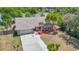 Charming single-story home featuring a well-maintained front yard, a driveway, and views of a serene lake at 3810 Hollister Pl, Brandon, FL 33511