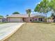 Charming single-story home with a well-manicured lawn and mature trees in the front yard at 3810 Hollister Pl, Brandon, FL 33511