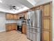 The kitchen features wooden cabinetry, stainless steel appliances, and wood-look flooring at 3810 Hollister Pl, Brandon, FL 33511