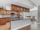 Kitchen with island, stainless appliances, tile backsplash, wood cabinets and breakfast nook in the background at 3810 Hollister Pl, Brandon, FL 33511