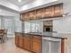 Kitchen island with granite countertops, stainless steel appliances and wood cabinets at 3810 Hollister Pl, Brandon, FL 33511
