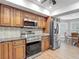 Kitchen with stainless steel appliances, granite countertops and wooden cabinets, adjacent to breakfast nook at 3810 Hollister Pl, Brandon, FL 33511