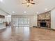 Living room with view to kitchen, breakfast nook, screened-in lanai and stone fireplace at 3810 Hollister Pl, Brandon, FL 33511