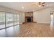 Living room with stone fireplace and view to a screened-in lanai through sliding glass doors at 3810 Hollister Pl, Brandon, FL 33511