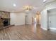 Spacious open-concept living room featuring a stone fireplace and modern flooring at 3810 Hollister Pl, Brandon, FL 33511