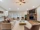 Spacious living room with a stone fireplace, ceiling fan, neutral decor, and lots of natural light at 3810 Hollister Pl, Brandon, FL 33511